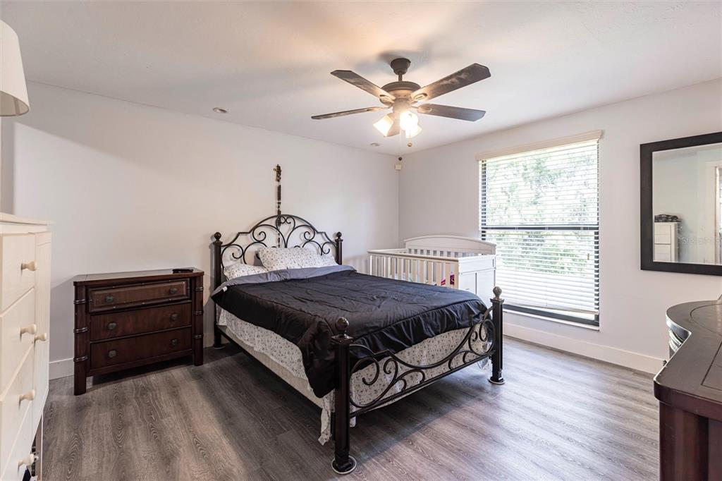 2345 Outrigger Lane Naples, FL 34104 - Photo 14 of 37 a bedroom with a bed window and a ceiling fan