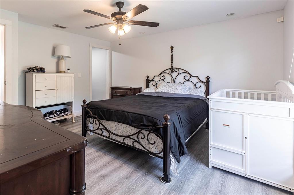 2345 Outrigger Lane Naples, FL 34104 - Photo 15 of 37 a bedroom with a bed and a chandelier