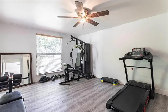 a view of a room with gym equipment and windows