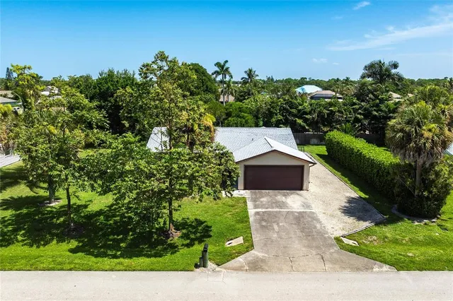 an aerial view of a house with swimming pool garden and patio