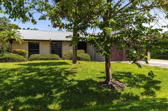 a view of a house with a tree in a yard
