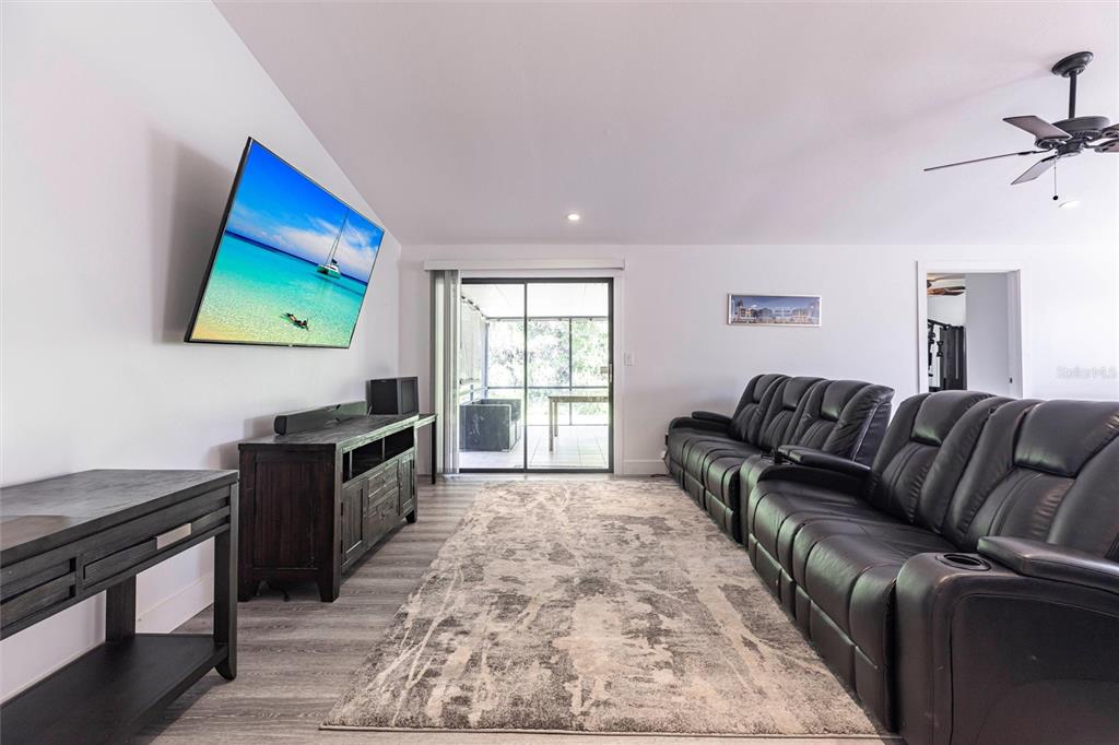 2345 Outrigger Lane Naples, FL 34104 - Photo 4 of 37 a living room with furniture and a flat screen tv