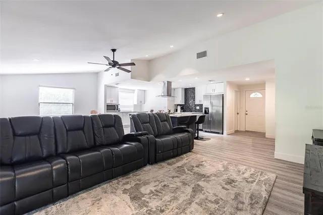 a living room with a couch and chandelier