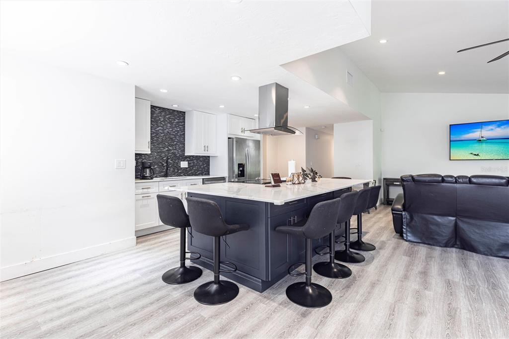 2345 Outrigger Lane Naples, FL 34104 - Photo 7 of 37 a living room with furniture and wooden floor