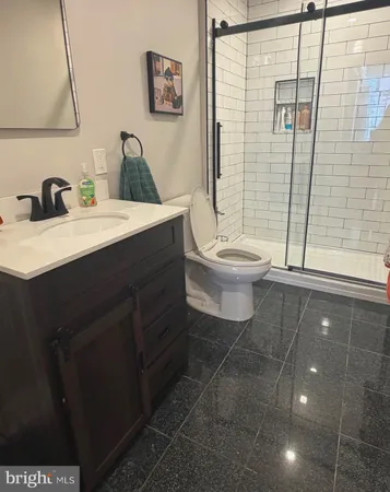 a bathroom with a toilet sink and shower