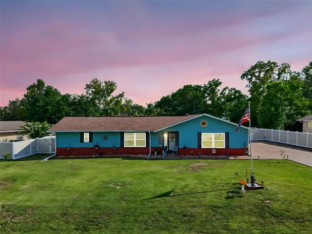 a front view of house with yard and green space