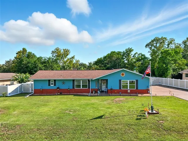 a aerial view of a house with swimming pool having outdoor seating