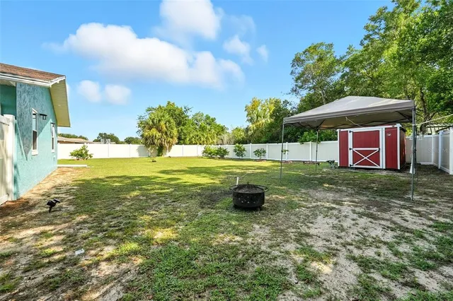an aerial view of residential houses with outdoor space and trees