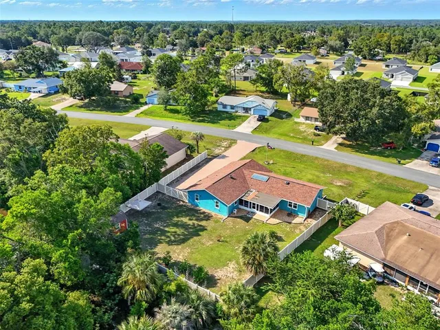 an aerial view of a house with garden space and street view