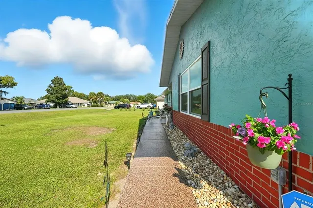 a front view of a house with a garden and seating space