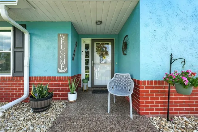 a view of a hallway with wooden floor and entryway