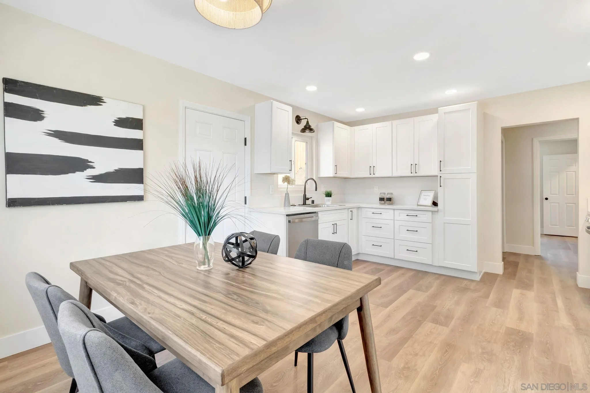 9188 Valencia Street Spring Valley, CA 91977 - Photo 11 of 27 a kitchen with kitchen island a table and chairs in it