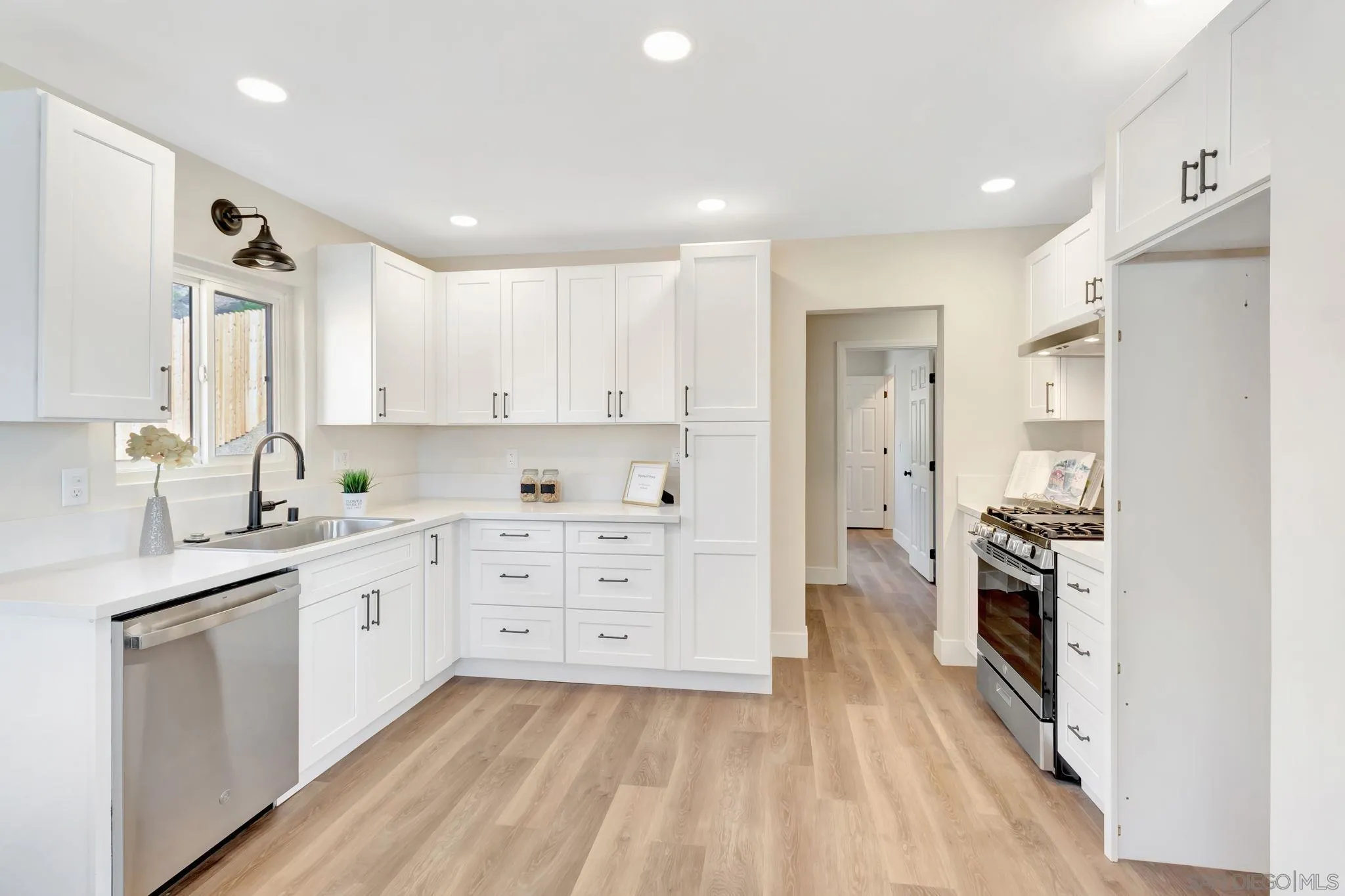 9188 Valencia Street Spring Valley, CA 91977 - Photo 15 of 27 a kitchen with a sink stove and refrigerator