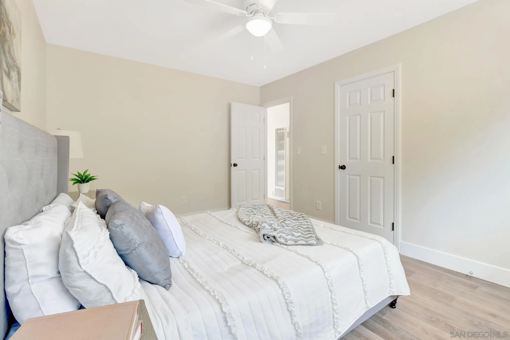 9188 Valencia Street Spring Valley, CA 91977 - Photo 20 of 27 a bedroom with a bed and a chandelier