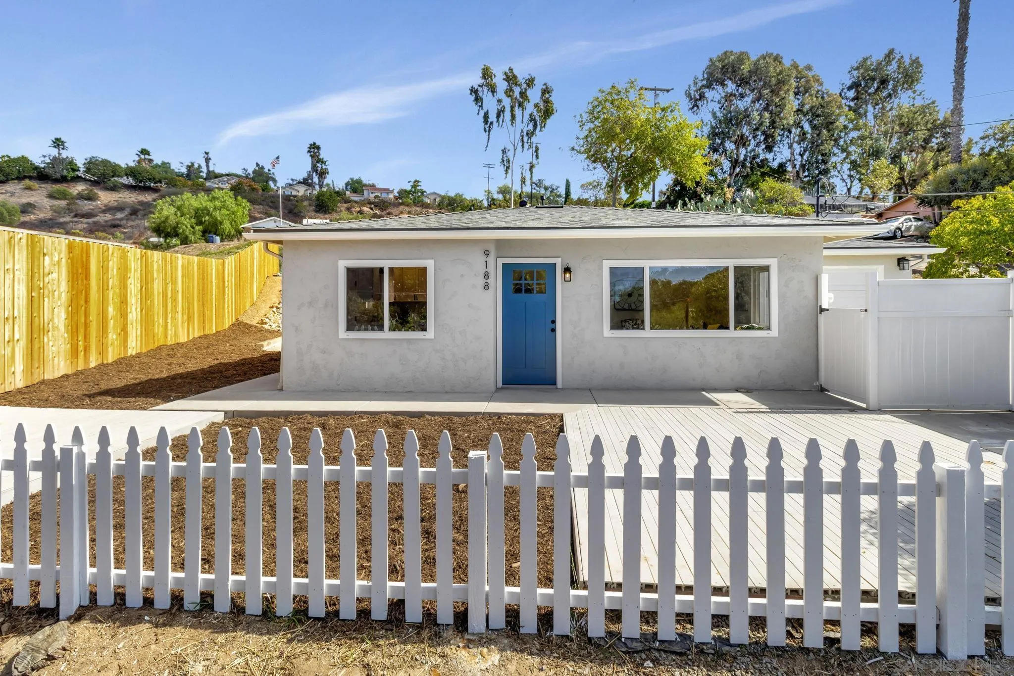 9188 Valencia Street Spring Valley, CA 91977 - Photo 2 of 27 a view of a house with a wooden fence