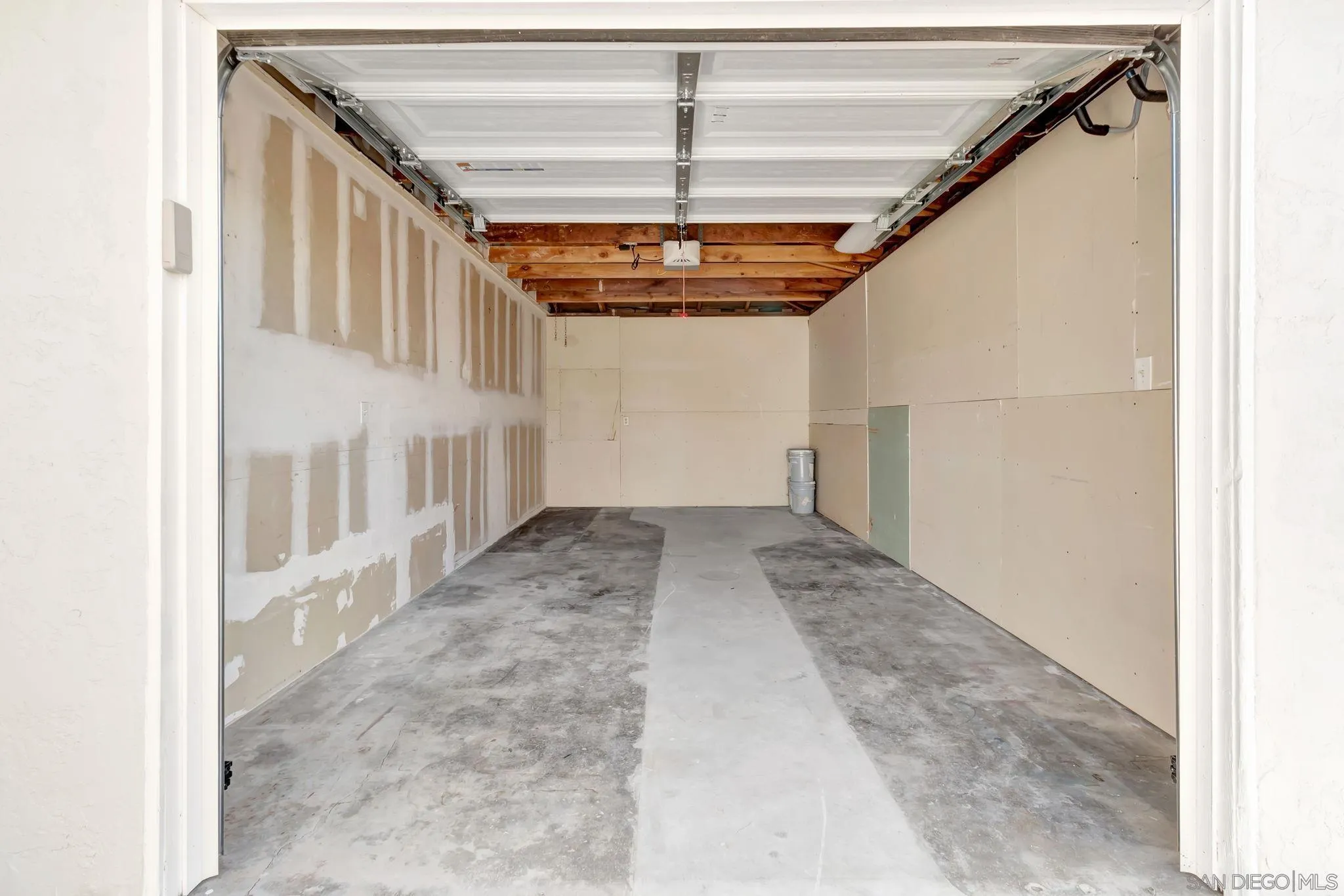 9188 Valencia Street Spring Valley, CA 91977 - Photo 24 of 27 a view of a hallway with a white walls and stairs