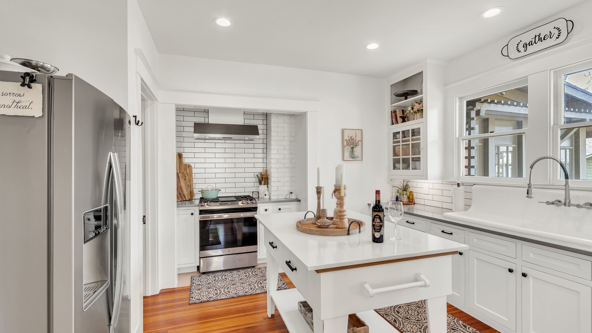 a kitchen with stainless steel appliances granite countertop a sink stove and refrigerator