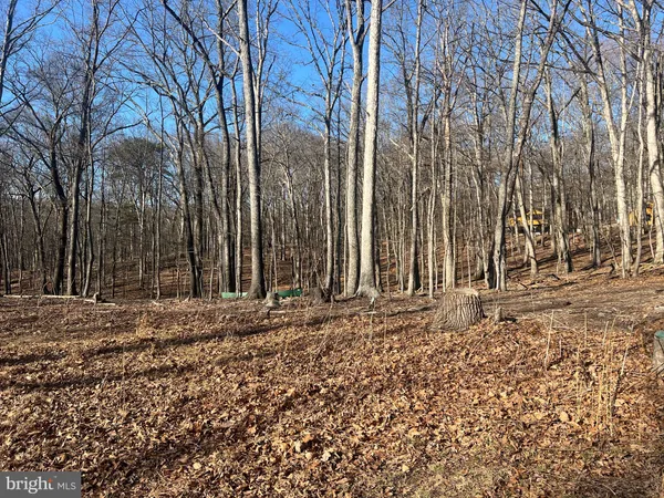 a wooden fence with some trees in the background