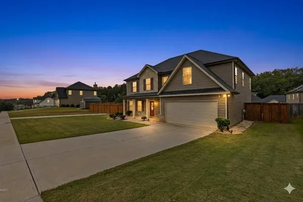 a front view of a house with a yard