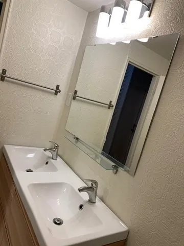 a white toilet sitting next to a bath tub