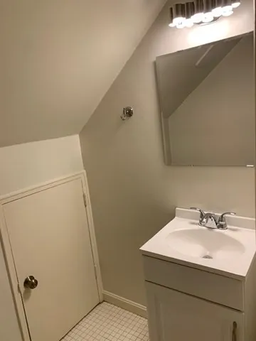 a bathroom with a sink and mirror