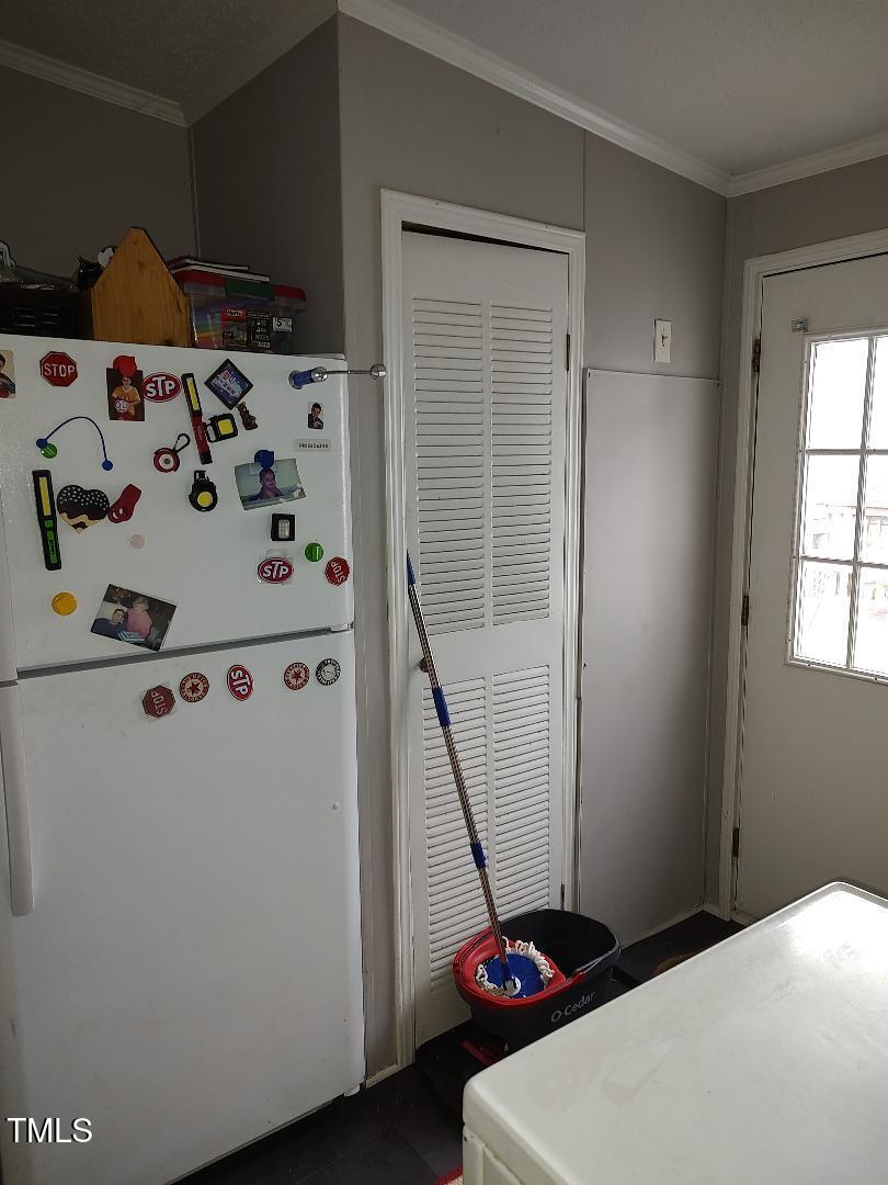 2960 Federal Road Benson, NC 27504 - Photo 37 of 45 Utility room has a back door that leads to the deck. Plenty of room for a freezer or extra fridge, washer and dryer, hotwater heater is easily accessible in this room also