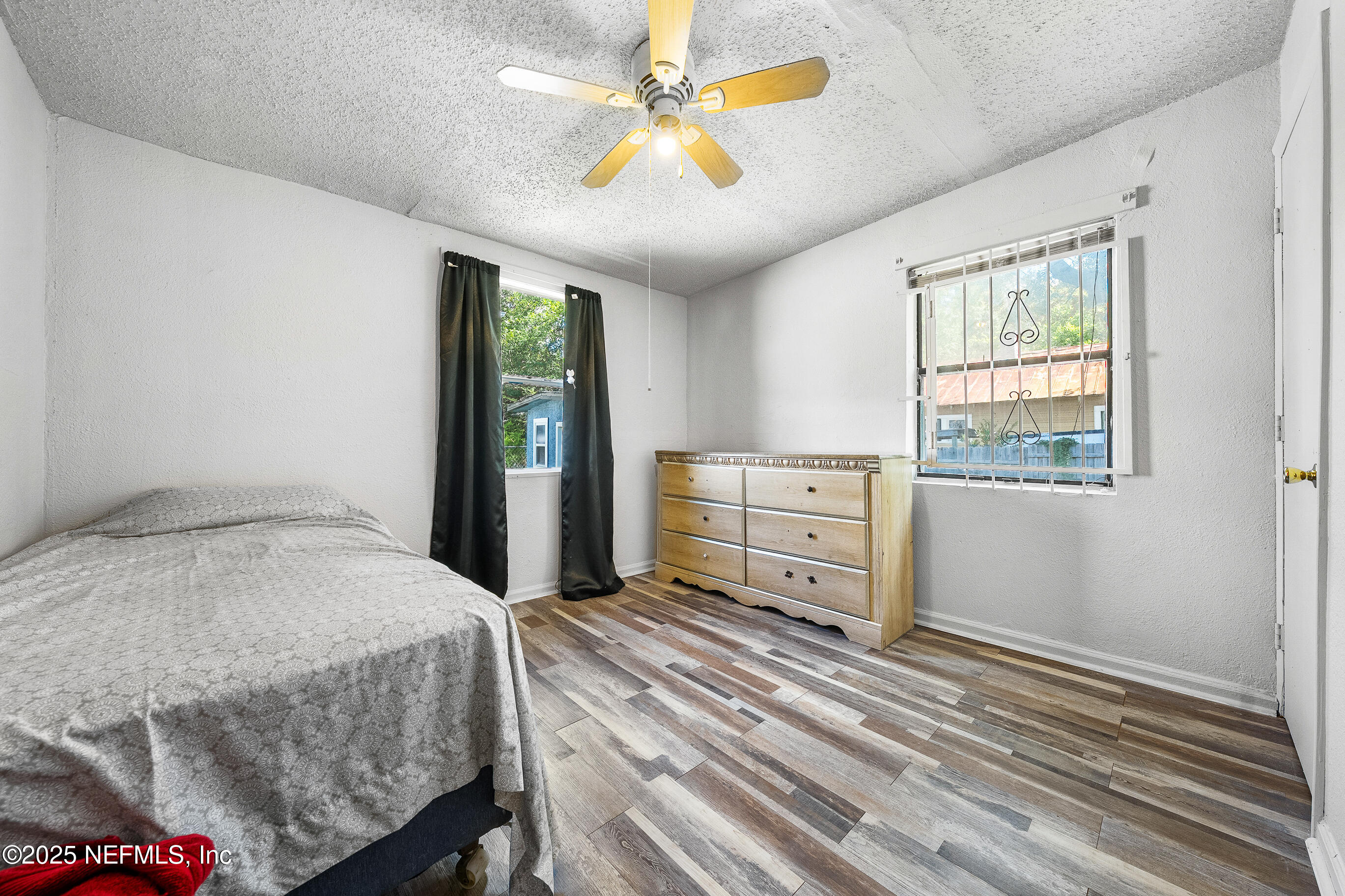 843 Line Street Jacksonville, FL 32209 - Photo 11 of 13 a bedroom with a bed and a dresser
