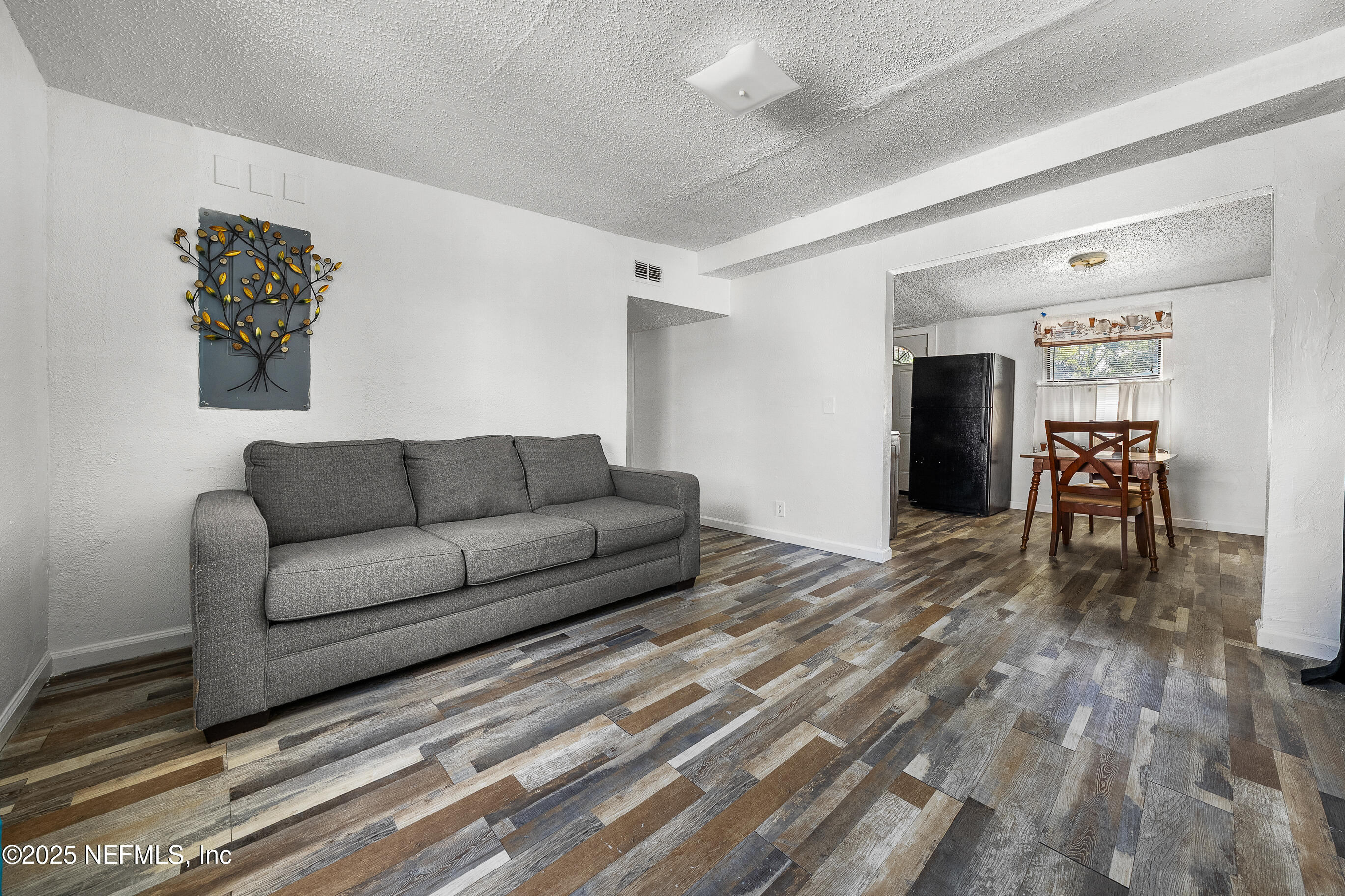 843 Line Street Jacksonville, FL 32209 - Photo 3 of 13 a living room with furniture and a dining table