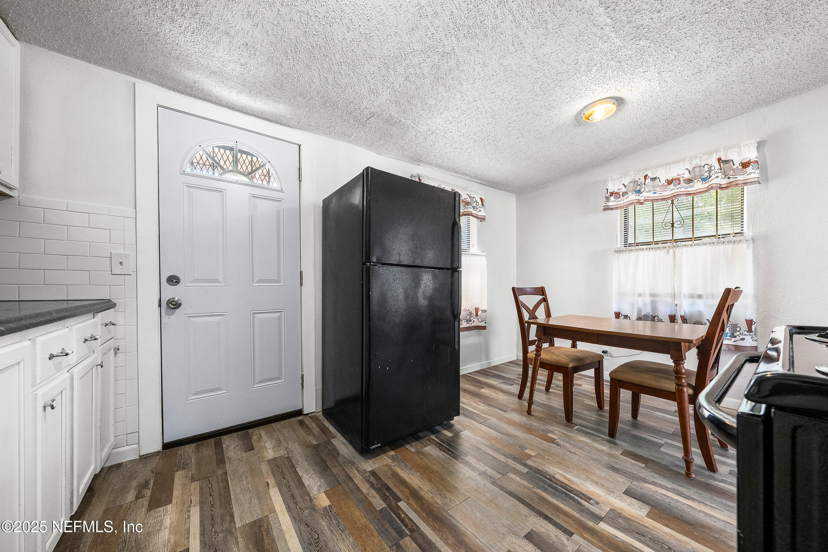 843 Line Street Jacksonville, FL 32209 - Photo 7 of 13 a view of a kitchen with furniture and wooden floor