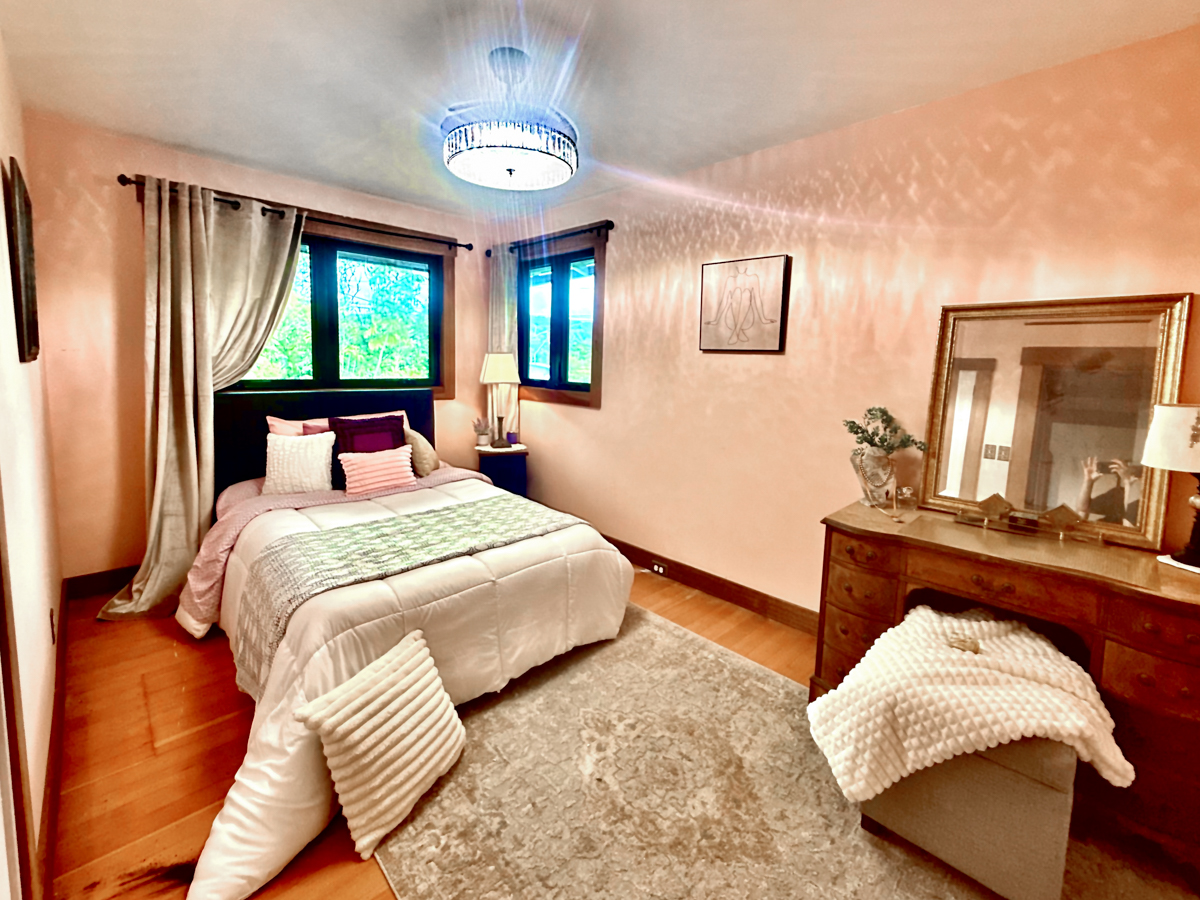 617 Ainako Avenue, Unit 1 Hilo, HI 96720 - Photo 22 of 29 a bedroom with a large bed and a window