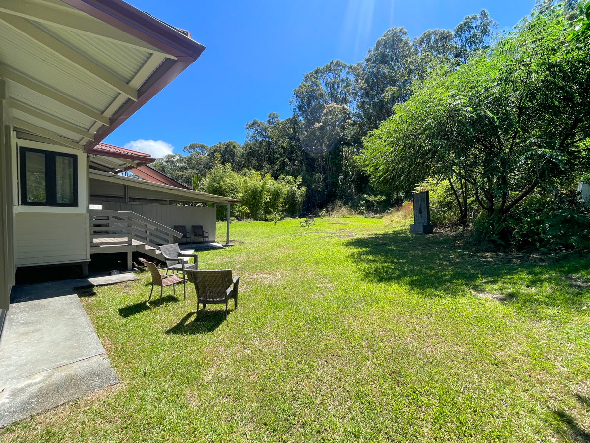 617 Ainako Avenue, Unit 1 Hilo, HI 96720 - Photo 27 of 29 a view of a backyard with table and chairs and potted plants