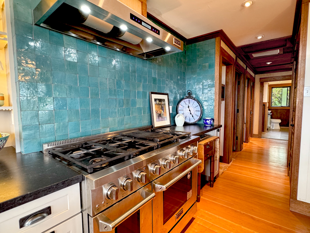 617 Ainako Avenue, Unit 1 Hilo, HI 96720 - Photo 5 of 29 a kitchen with stainless steel appliances granite countertop a stove a sink and a microwave