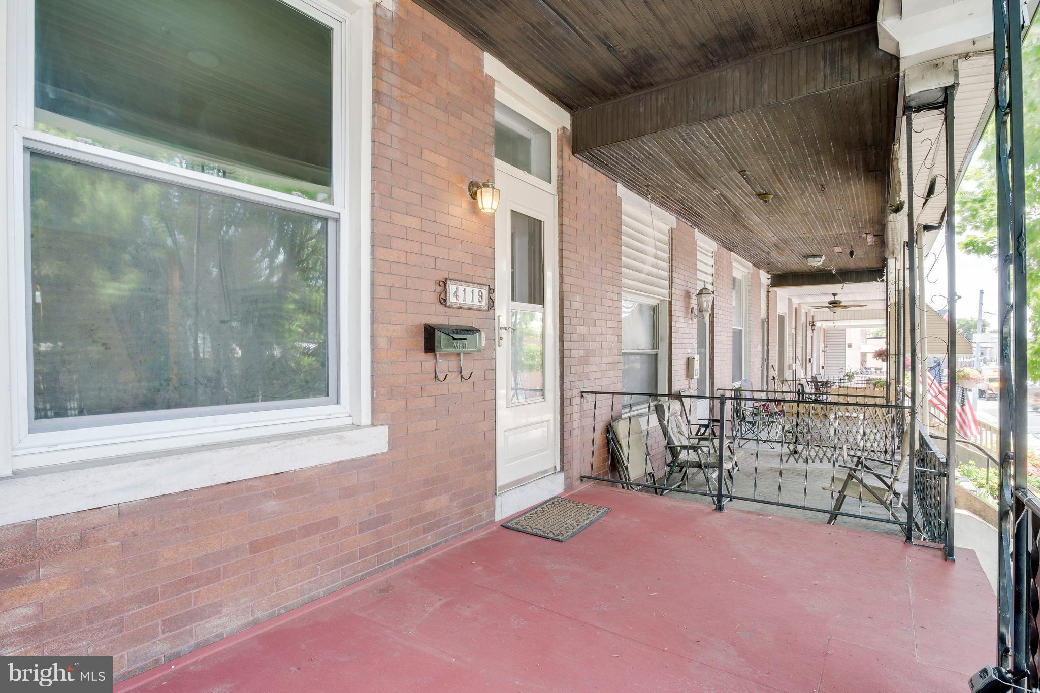 4119 Falls Road Baltimore, MD 21211 - Photo 2 of 23 elevated front porch shaded by trees