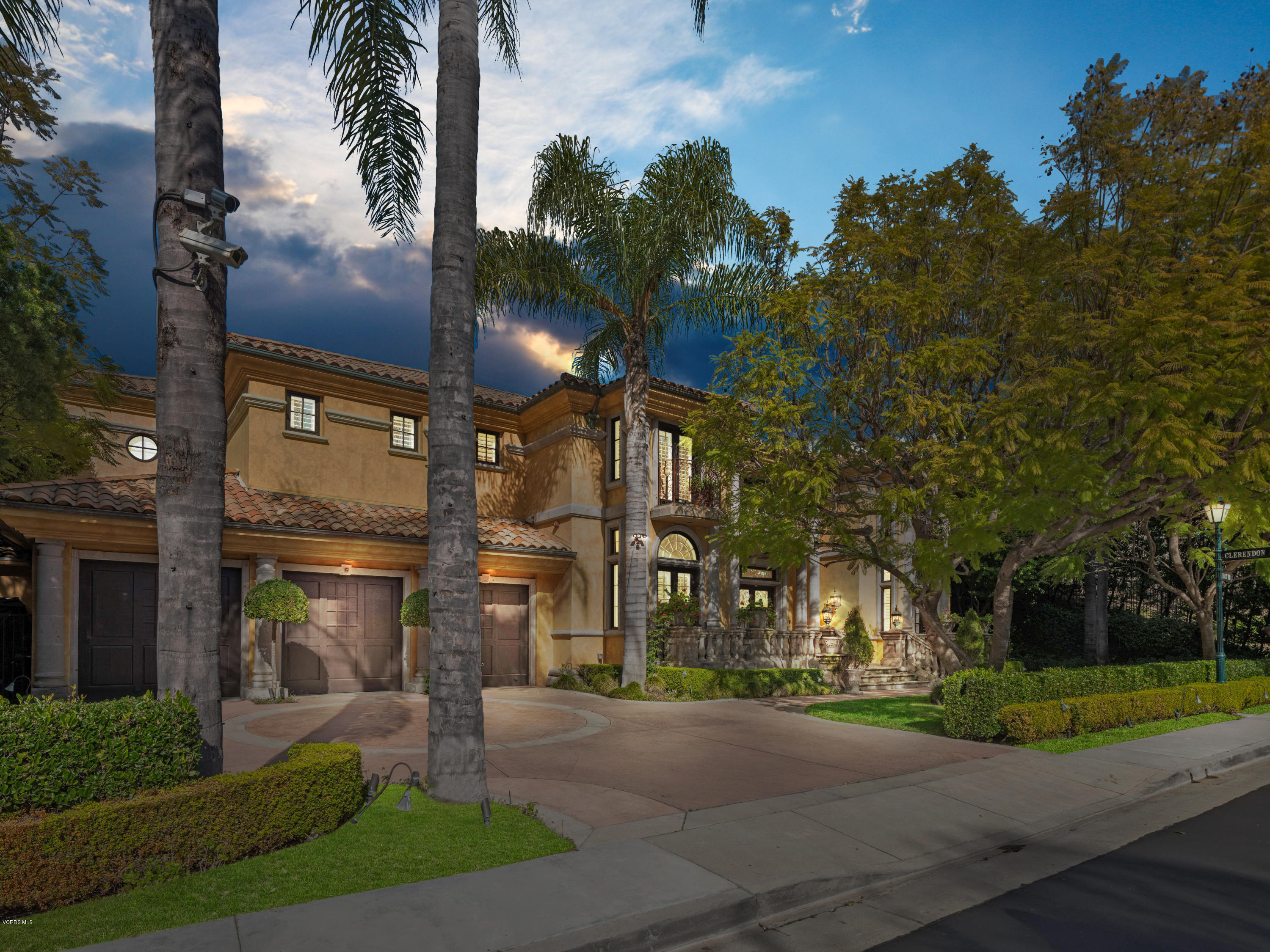 front view of a house with a yard and an trees