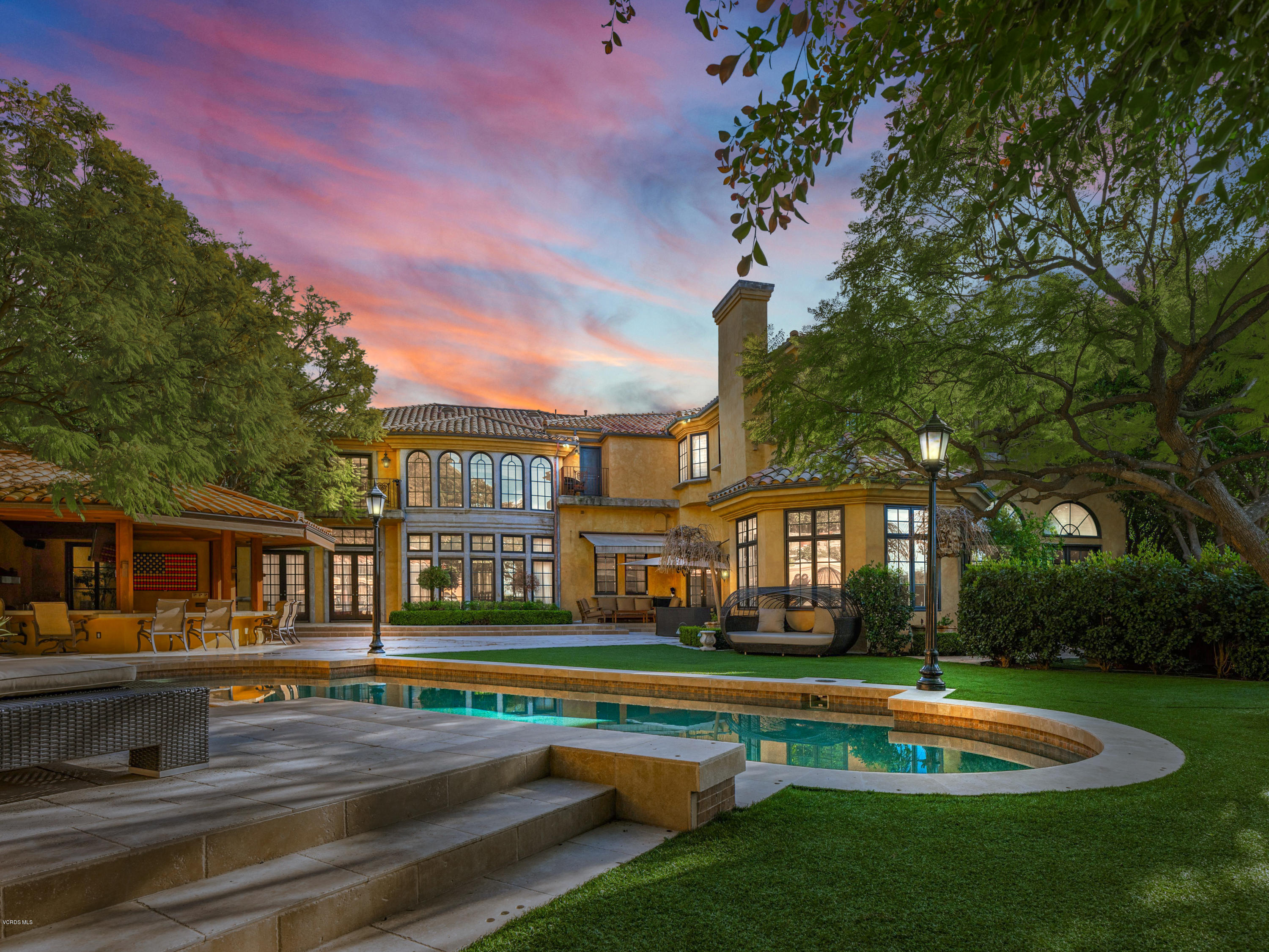 14003 Aubrey Road Beverly Hills, CA 90210 - Photo 5 of 49 a front view of a house with a yard table and chairs