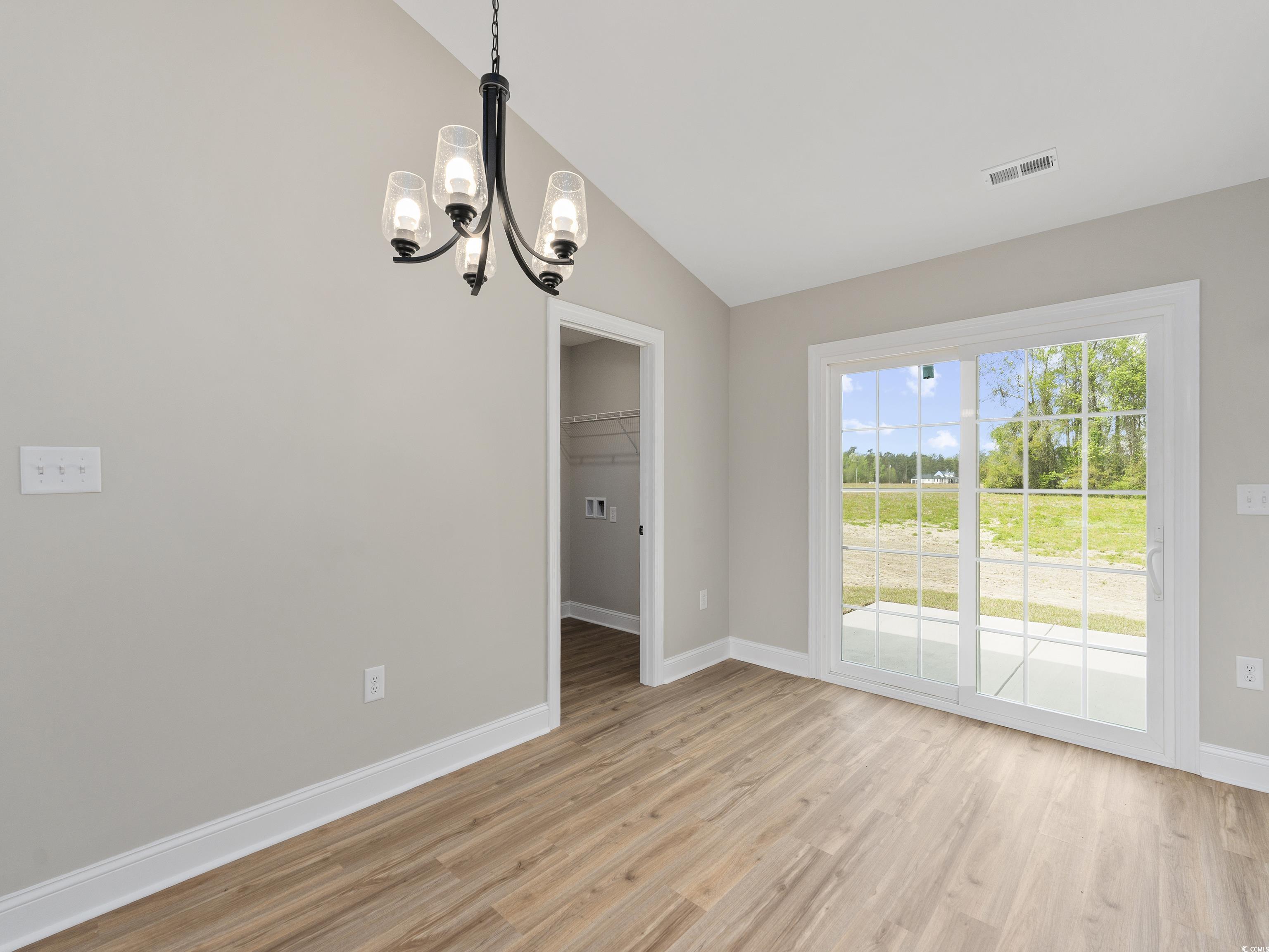 849 Highway 67 Loris Sc 29569 Loris, SC 29569 - Photo 11 of 28 Unfurnished dining area featuring visible vents, baseboards, an inviting chandelier, light wood-type flooring, and lofted ceiling