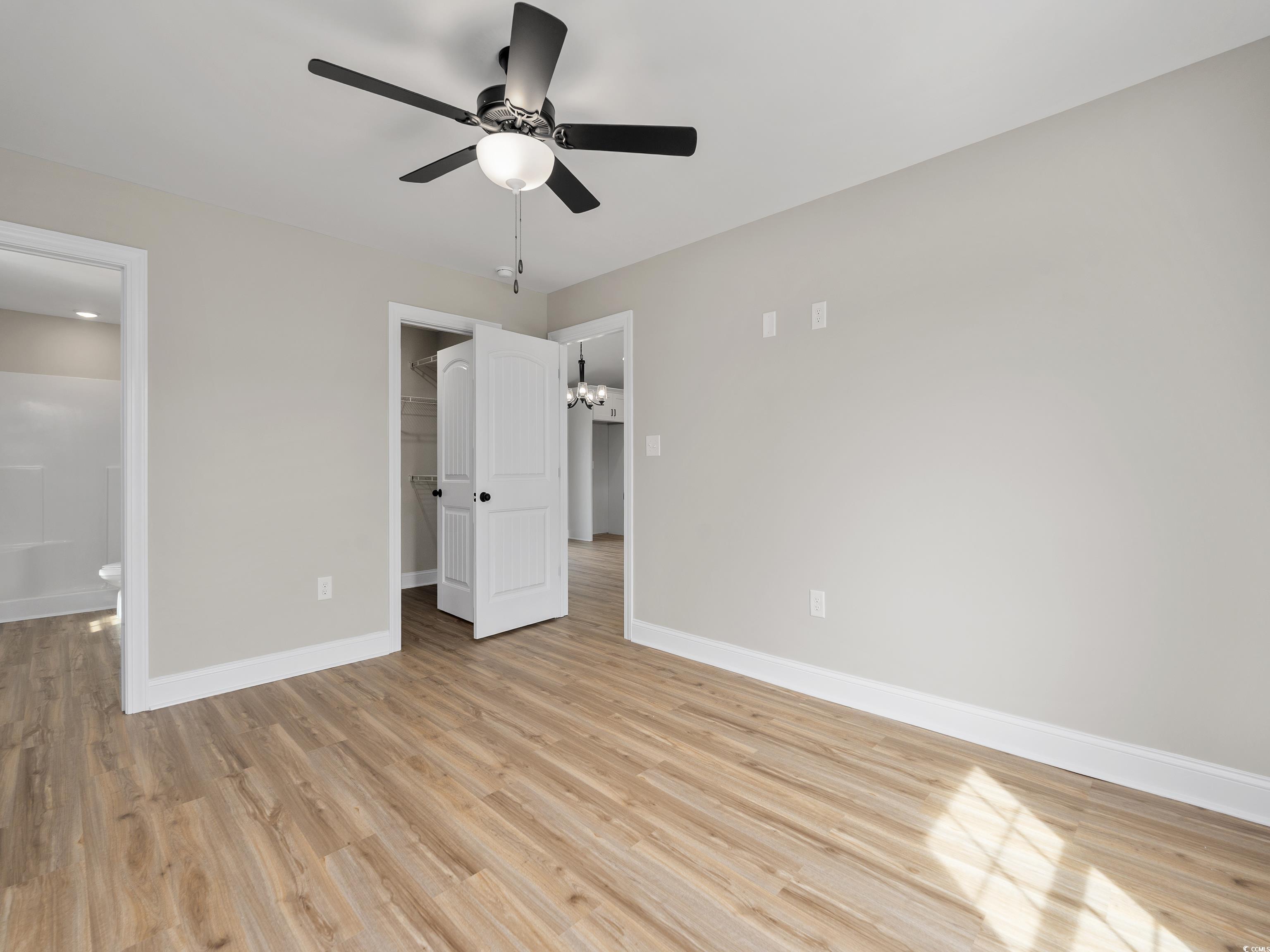 849 Highway 67 Loris Sc 29569 Loris, SC 29569 - Photo 15 of 28 Unfurnished bedroom featuring a closet, baseboards, ensuite bathroom, a spacious closet, and light wood-style flooring
