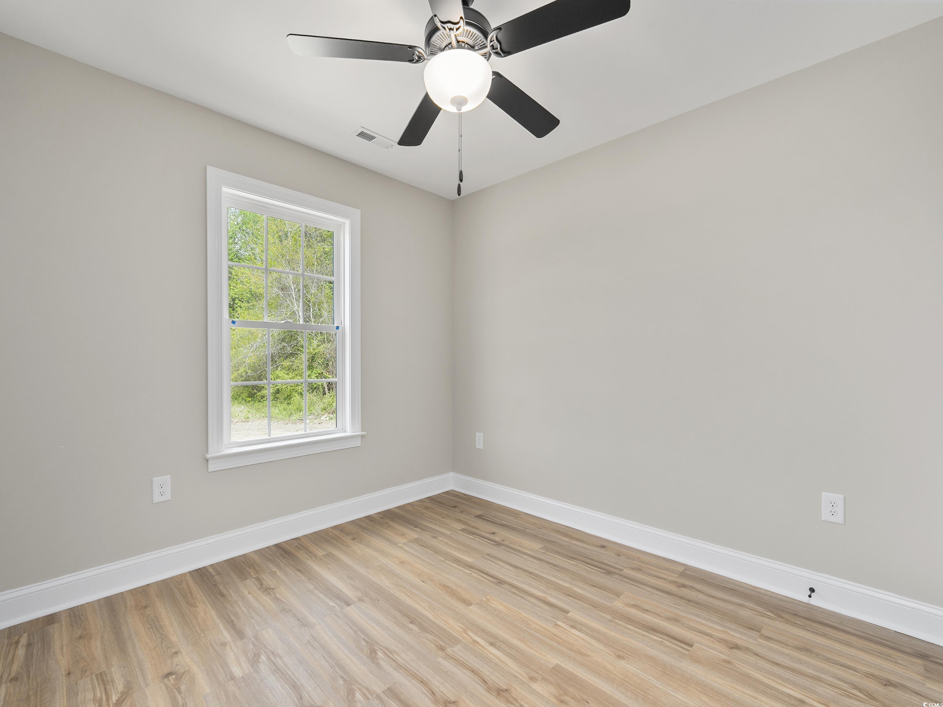 849 Highway 67 Loris Sc 29569 Loris, SC 29569 - Photo 21 of 28 Unfurnished room featuring visible vents, baseboards, a ceiling fan, and light wood-style floors