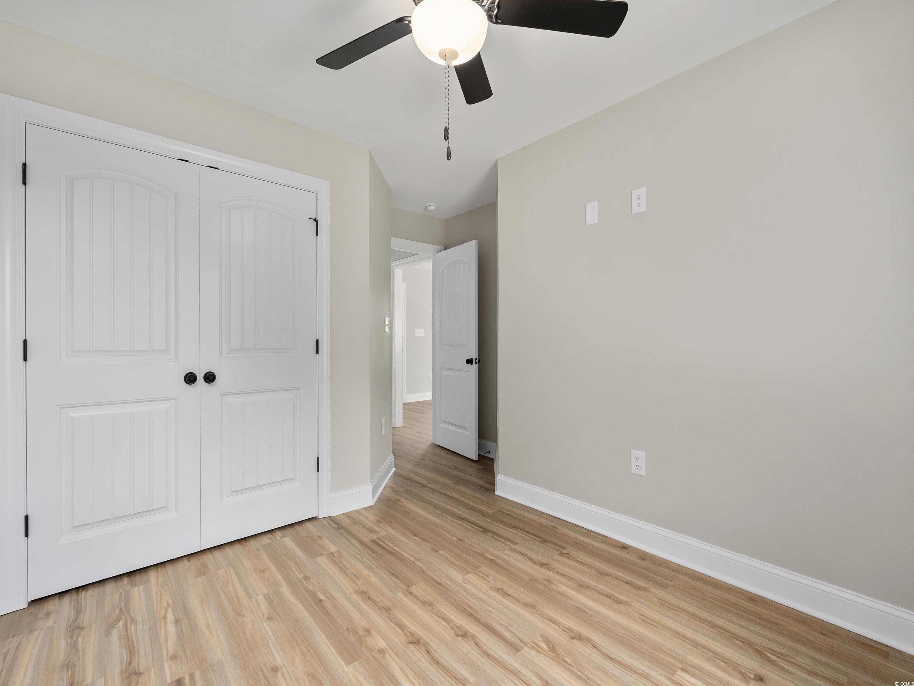 849 Highway 67 Loris Sc 29569 Loris, SC 29569 - Photo 22 of 28 Unfurnished bedroom featuring light wood-type flooring, a closet, baseboards, and a ceiling fan