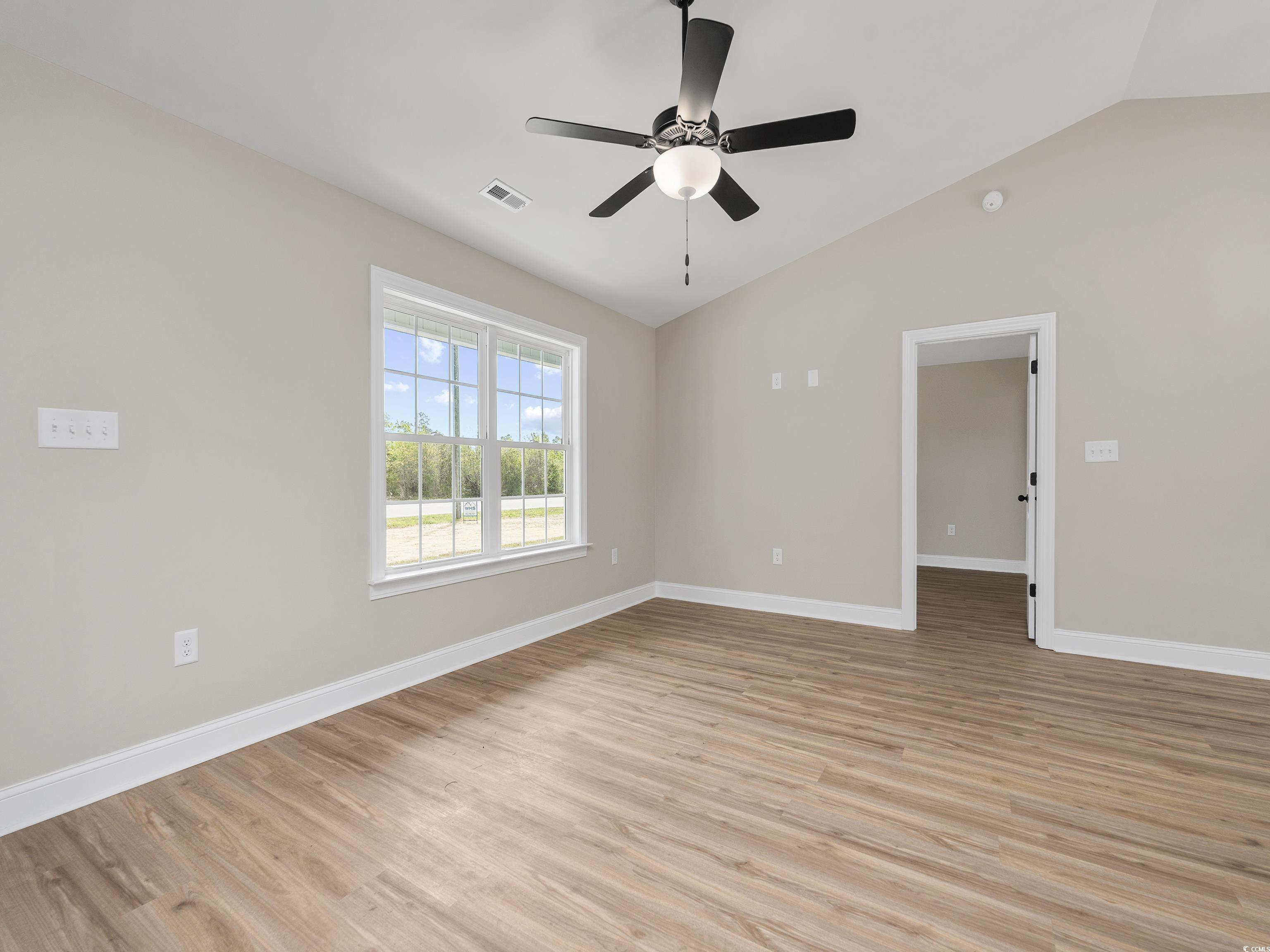 849 Highway 67 Loris Sc 29569 Loris, SC 29569 - Photo 23 of 28 Unfurnished room with light wood-style floors, baseboards, vaulted ceiling, and visible vents