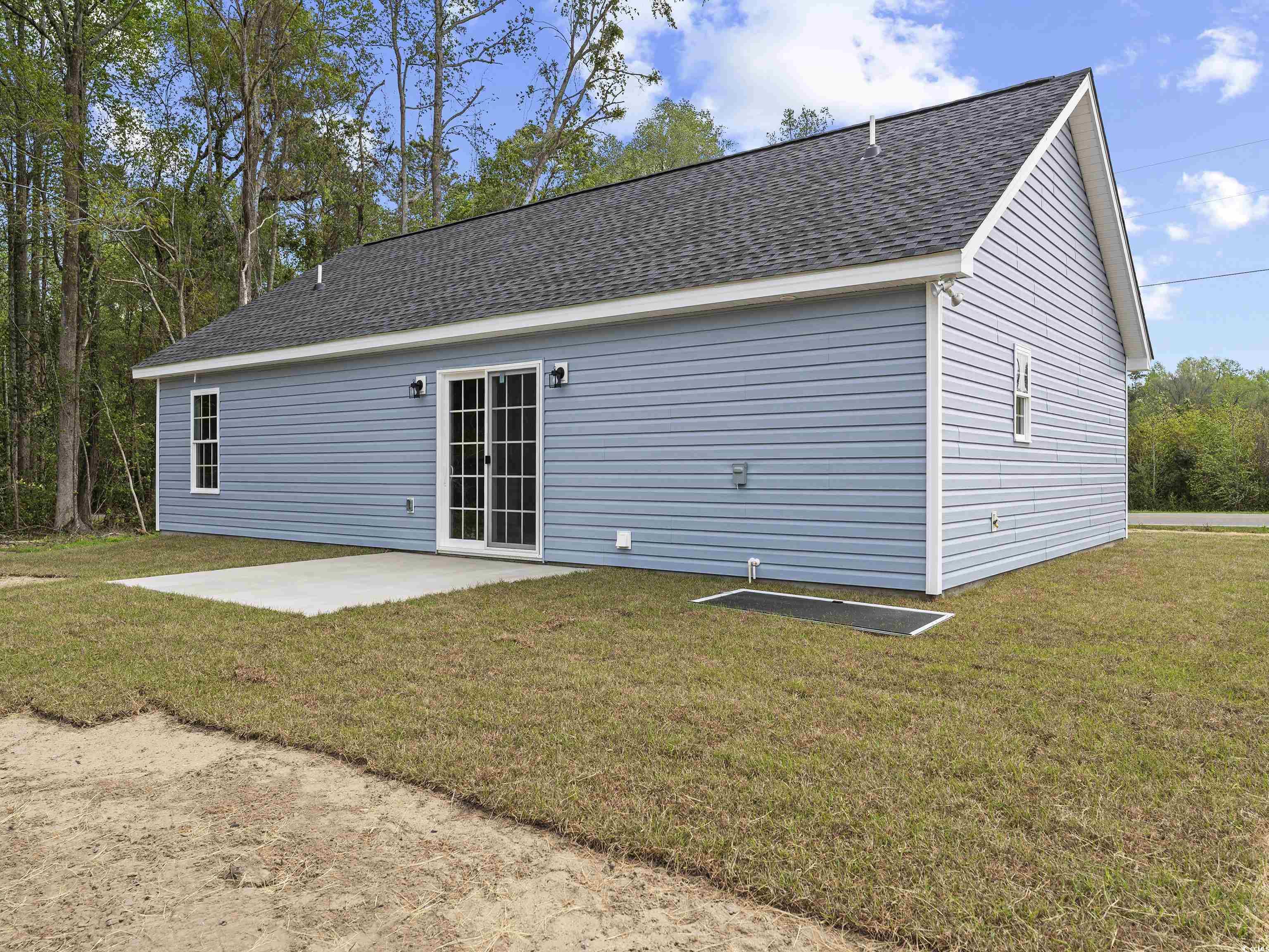 849 Highway 67 Loris Sc 29569 Loris, SC 29569 - Photo 3 of 28 Rear view of property featuring a patio area, a shingled roof, and a lawn