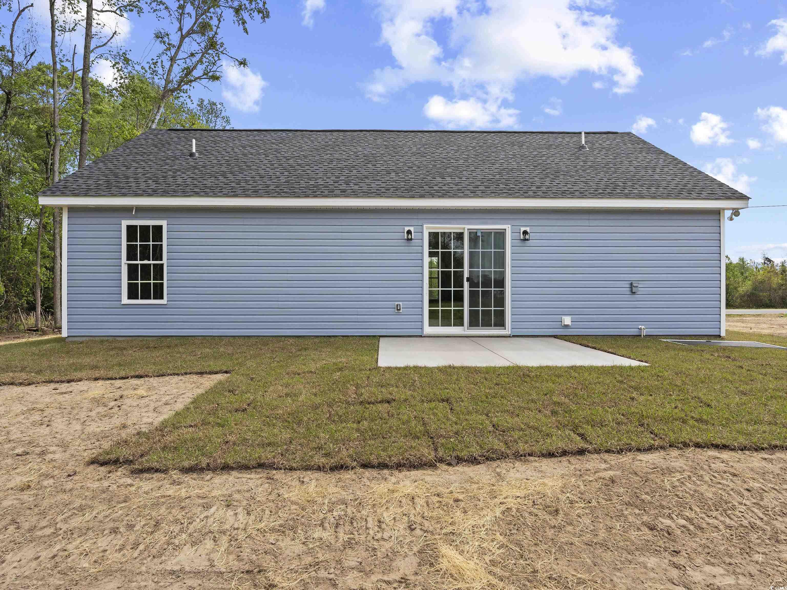 849 Highway 67 Loris Sc 29569 Loris, SC 29569 - Photo 4 of 28 Back of property featuring a patio area, a shingled roof, and a lawn