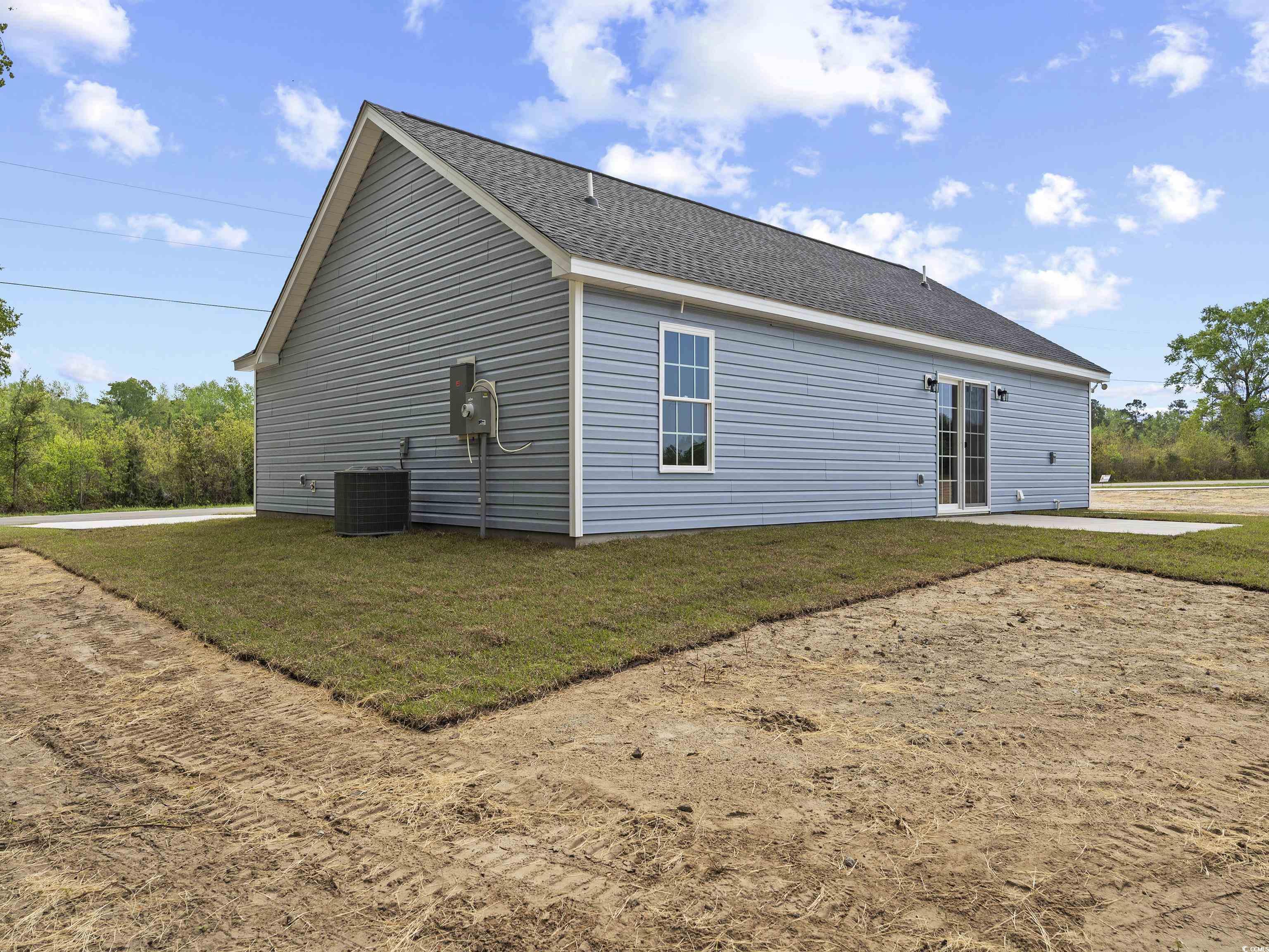 849 Highway 67 Loris Sc 29569 Loris, SC 29569 - Photo 5 of 28 Rear view of house with roof with shingles, a yard, and central AC unit