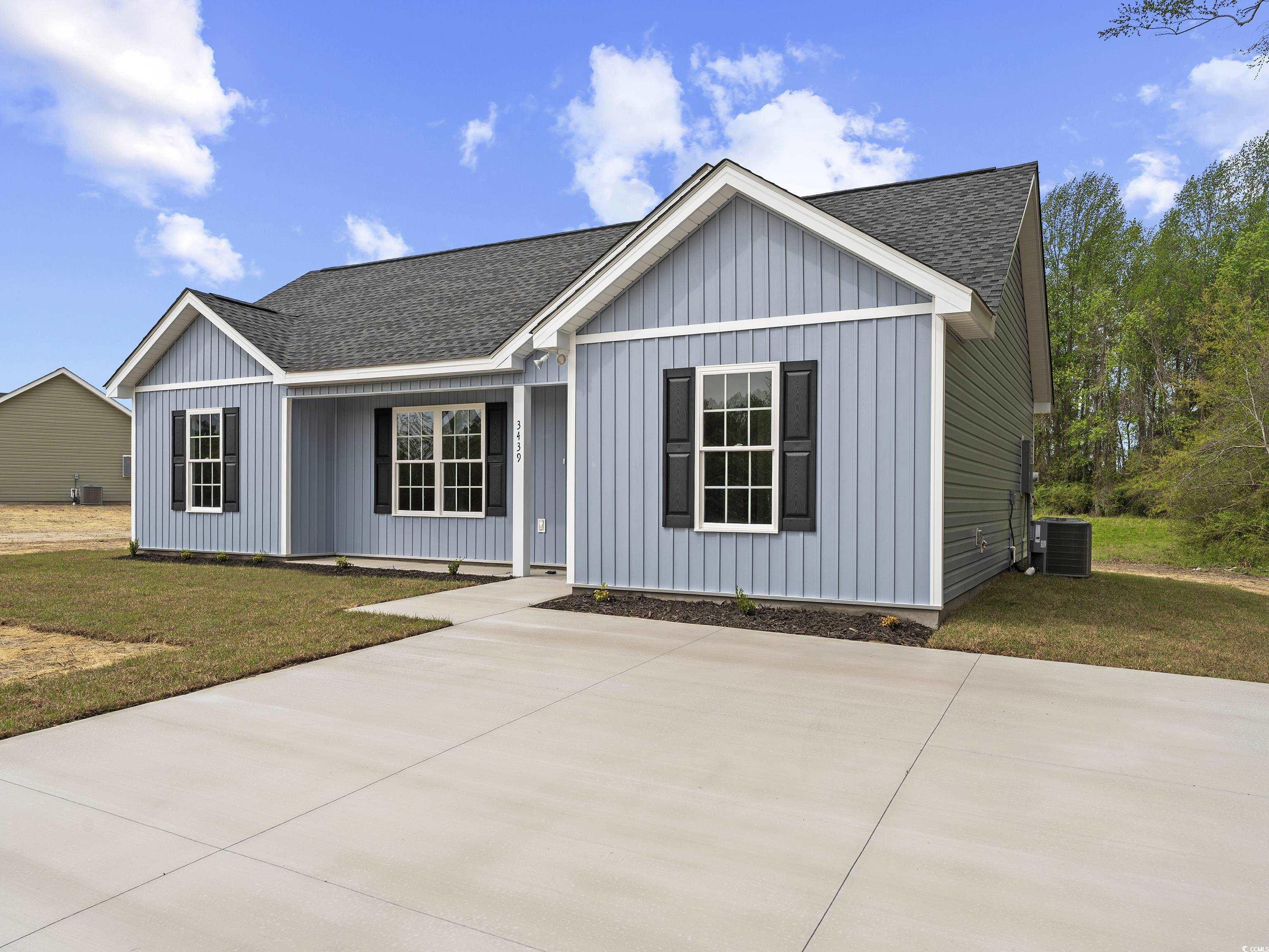 849 Highway 67 Loris Sc 29569 Loris, SC 29569 - Photo 6 of 28 View of front of home featuring a front yard, central AC, board and batten siding, concrete driveway, and roof with shingles