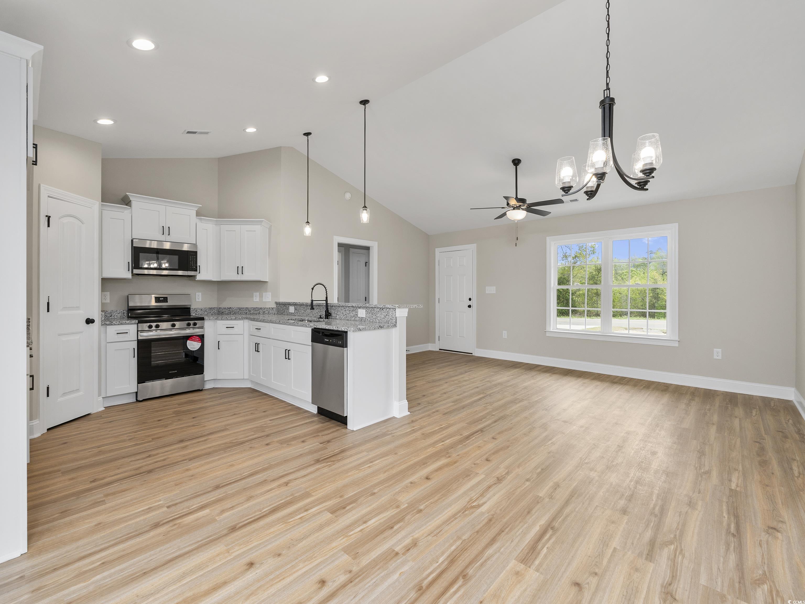 849 Highway 67 Loris Sc 29569 Loris, SC 29569 - Photo 28 of 28 Kitchen with open floor plan, a peninsula, light wood finished floors, and stainless steel appliances