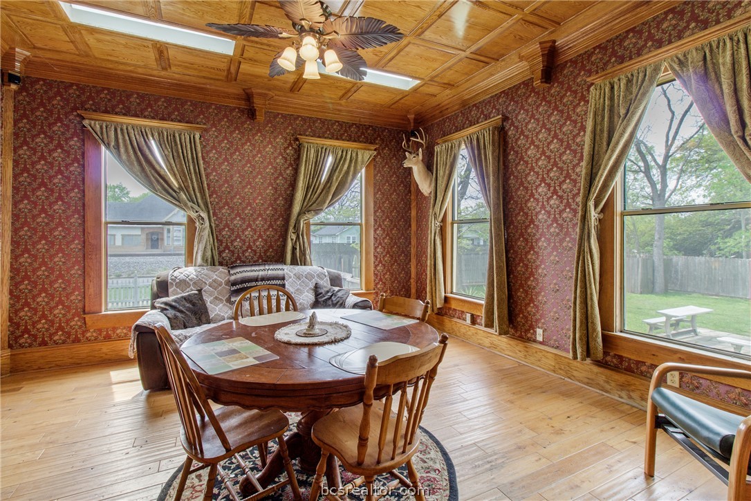 106 South Logan Avenue Bryan, TX 77803 - Photo 16 of 47 a view of a dining room with furniture wooden floor and a chandelier