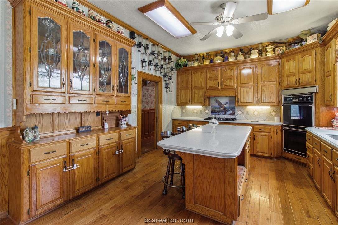 106 South Logan Avenue Bryan, TX 77803 - Photo 21 of 47 a kitchen with stainless steel appliances granite countertop a sink a stove counter space and cabinets