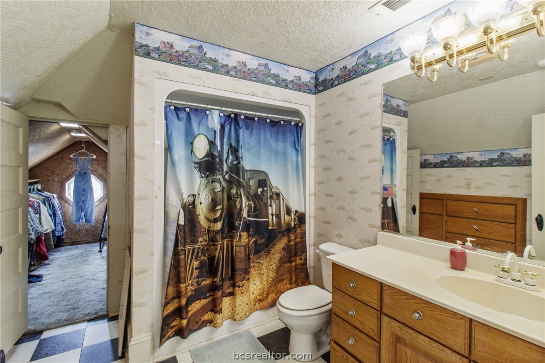 106 South Logan Avenue Bryan, TX 77803 - Photo 28 of 47 a bathroom with a toilet sink and mirror