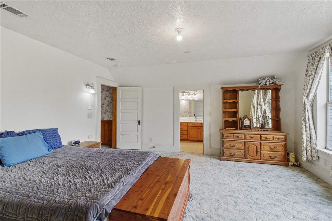 106 South Logan Avenue Bryan, TX 77803 - Photo 33 of 47 a bedroom with a large bed and dresser