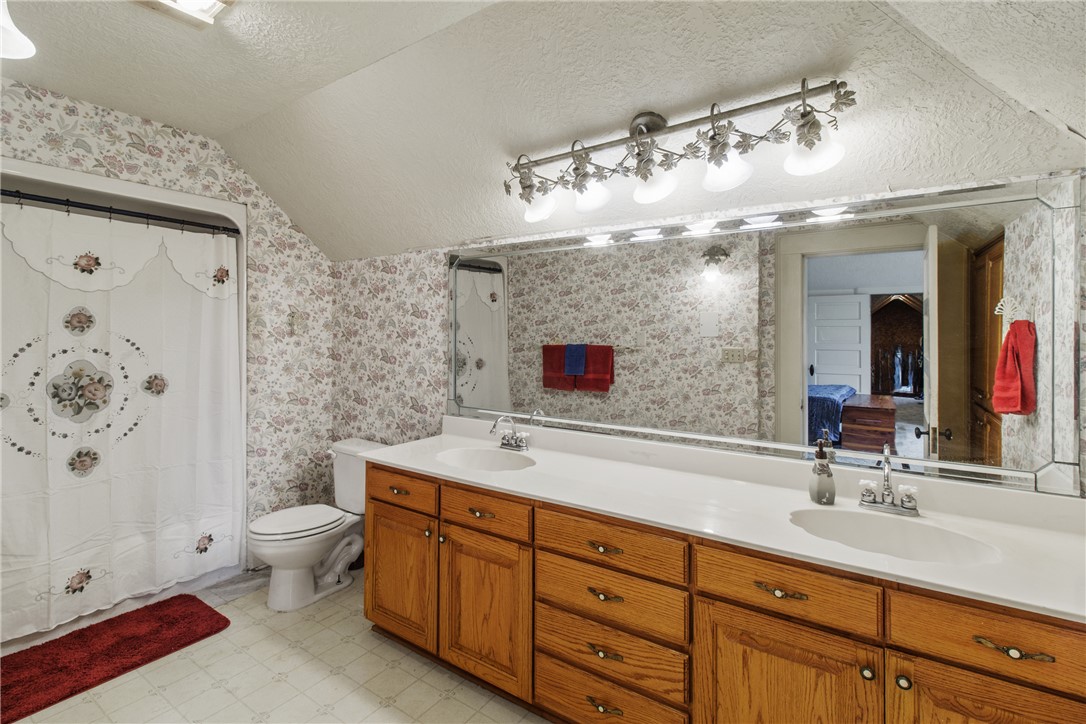 106 South Logan Avenue Bryan, TX 77803 - Photo 35 of 47 a spacious bathroom with a double vanity sink mirror and toilet